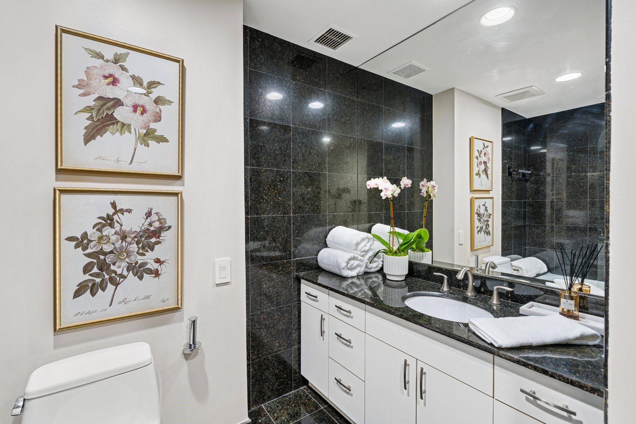 2001 Holcombe Boulevard, Unit PH4 Houston, TX 77030 - Photo 12 of 46 a bathroom with a sink a mirror and a shower