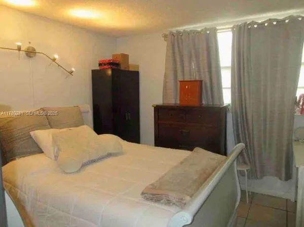 a bedroom with a bed and a mirror