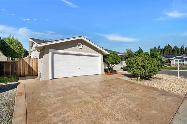 a view of a house with a yard and garage