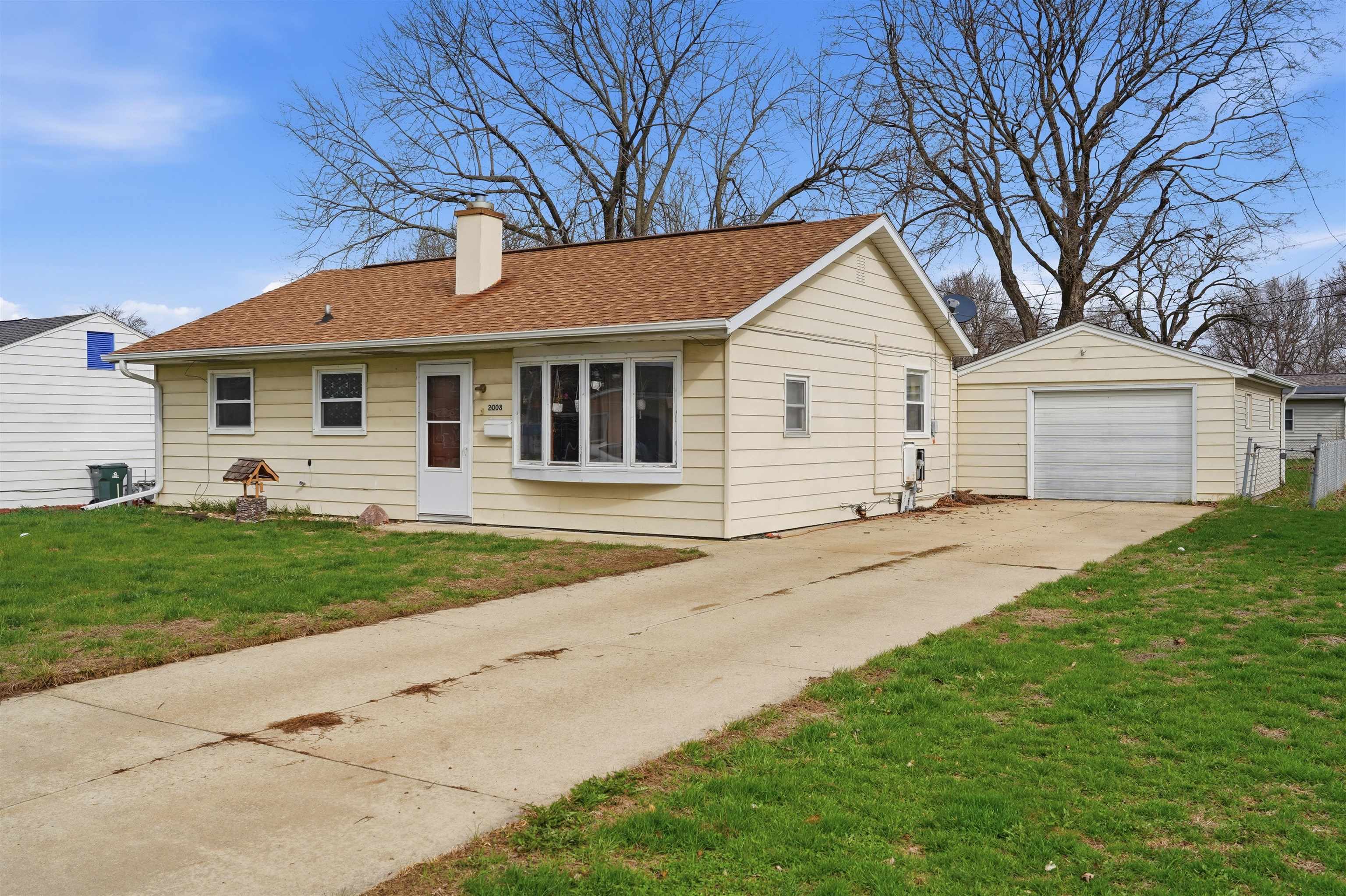2008 East 6th Street Sterling, IL 61081 - Photo 1 of 16 a front view of a house with a garden and yard