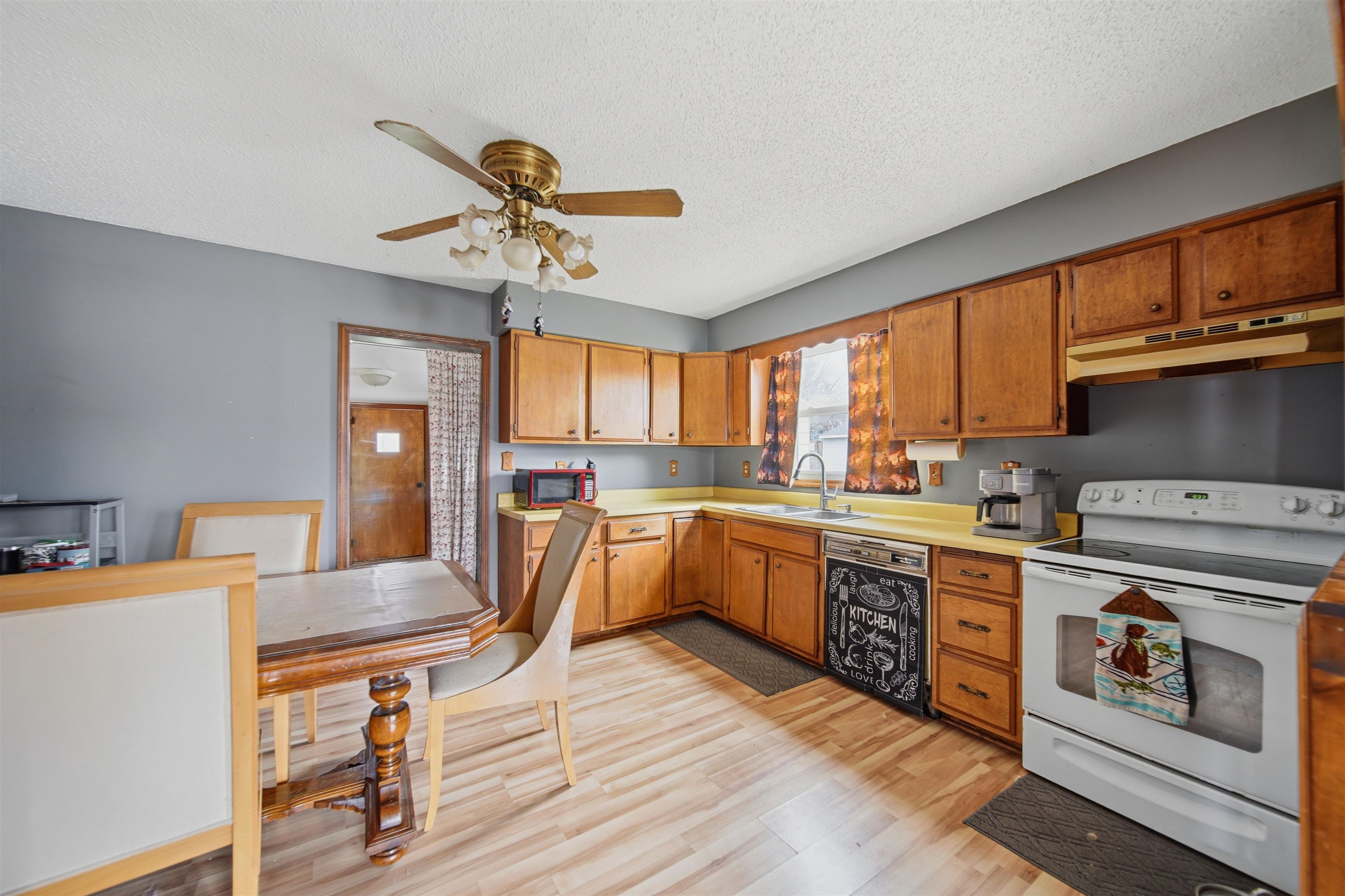 2008 East 6th Street Sterling, IL 61081 - Photo 6 of 16 a kitchen with stainless steel appliances granite countertop a stove a sink dishwasher and a refrigerator with wooden floor