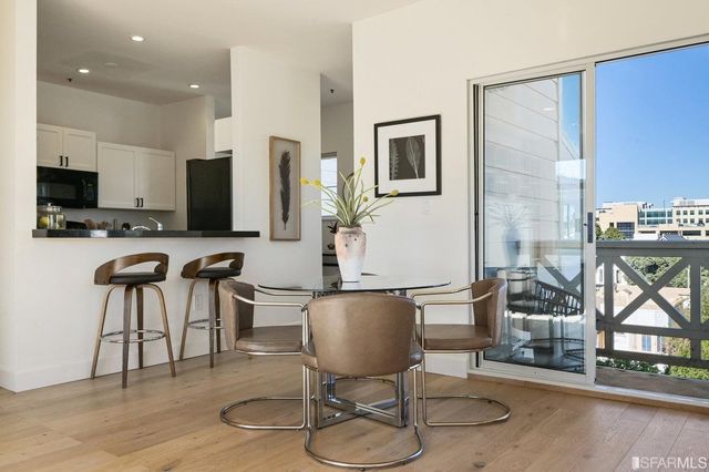 a view of a kitchen with dining table and chairs