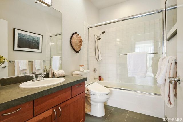 a bathroom with a sink toilet a mirror and shower