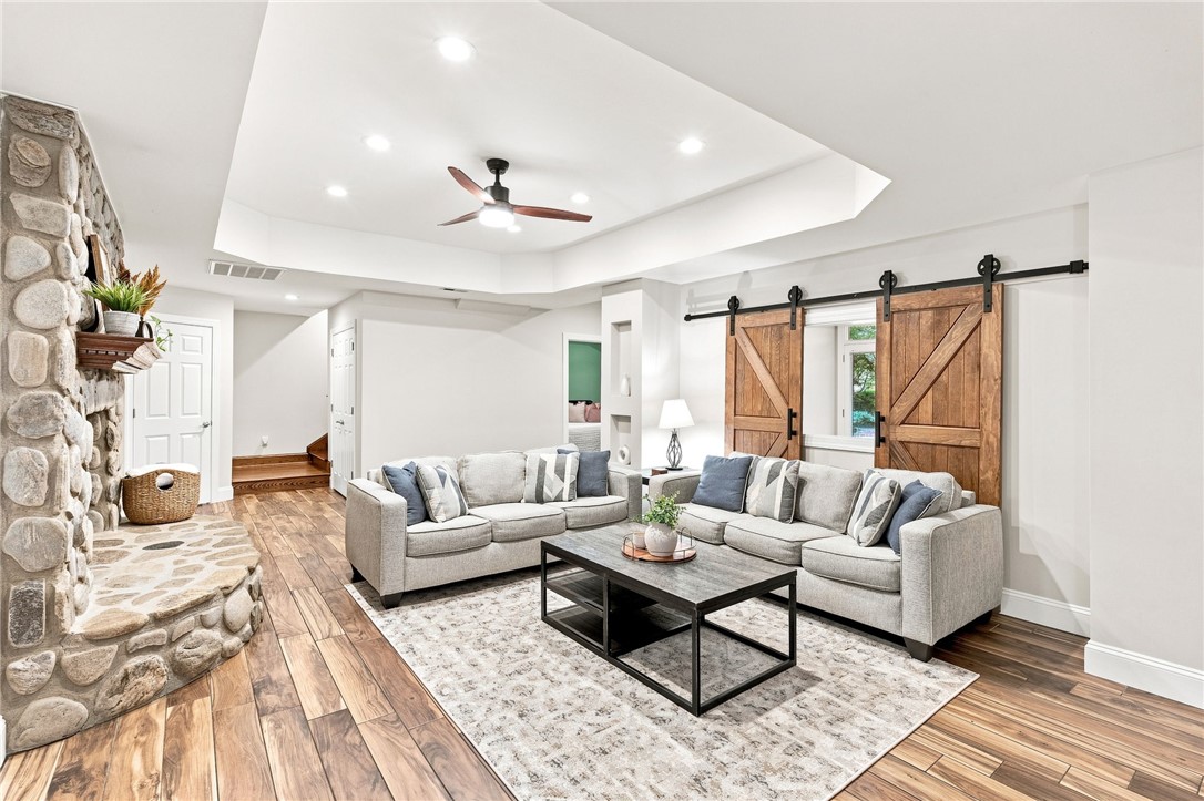 320 Watson Road Easley, SC 29642 - Photo 32 of 50 Rich wood floors and a stone fireplace anchor this inviting living space.