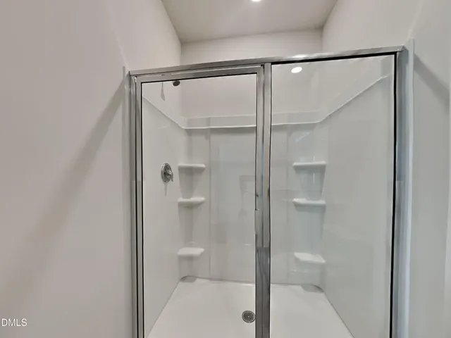 a bathroom with a glass shower door