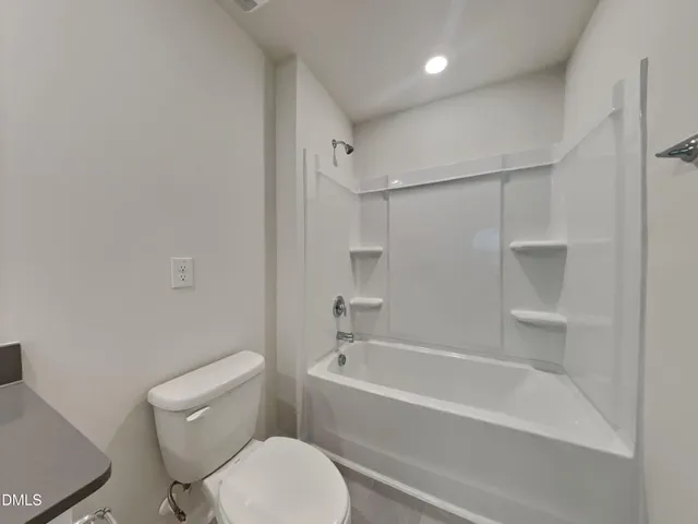 a bathroom with a toilet and a bathtub