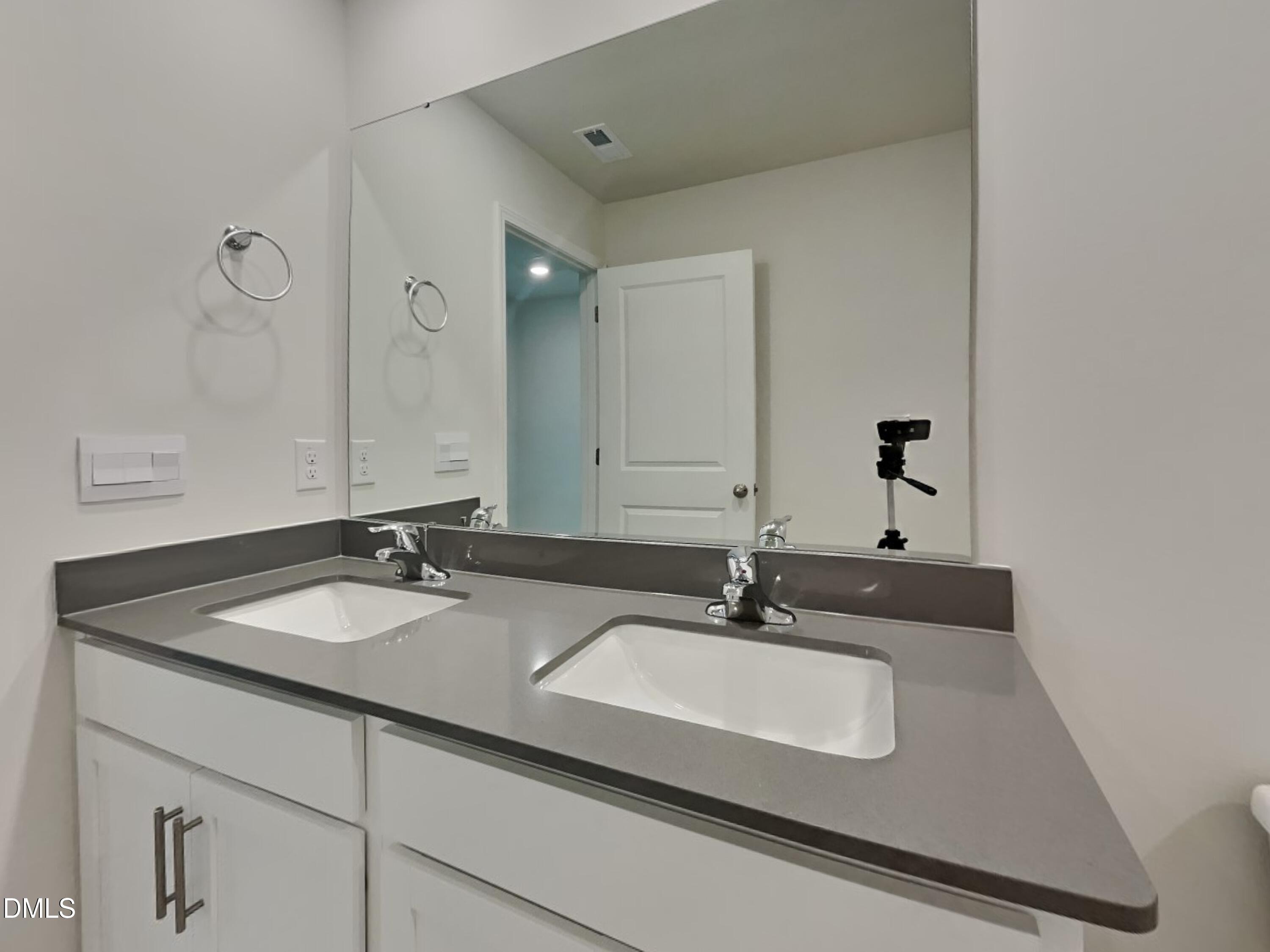 141 Chapel Drive Fuquay-Varina, NC 27526 - Photo 15 of 18 a bathroom with a sink and a mirror