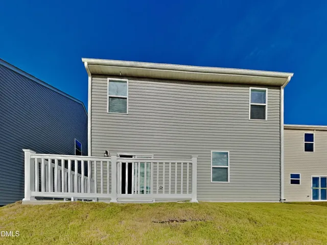 a view of a house with a backyard