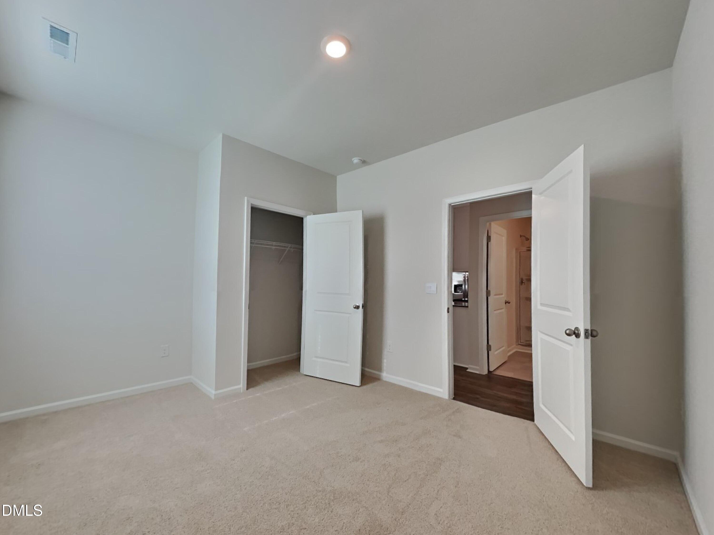 141 Chapel Drive Fuquay-Varina, NC 27526 - Photo 7 of 18 a view of a big room with closet and entryway