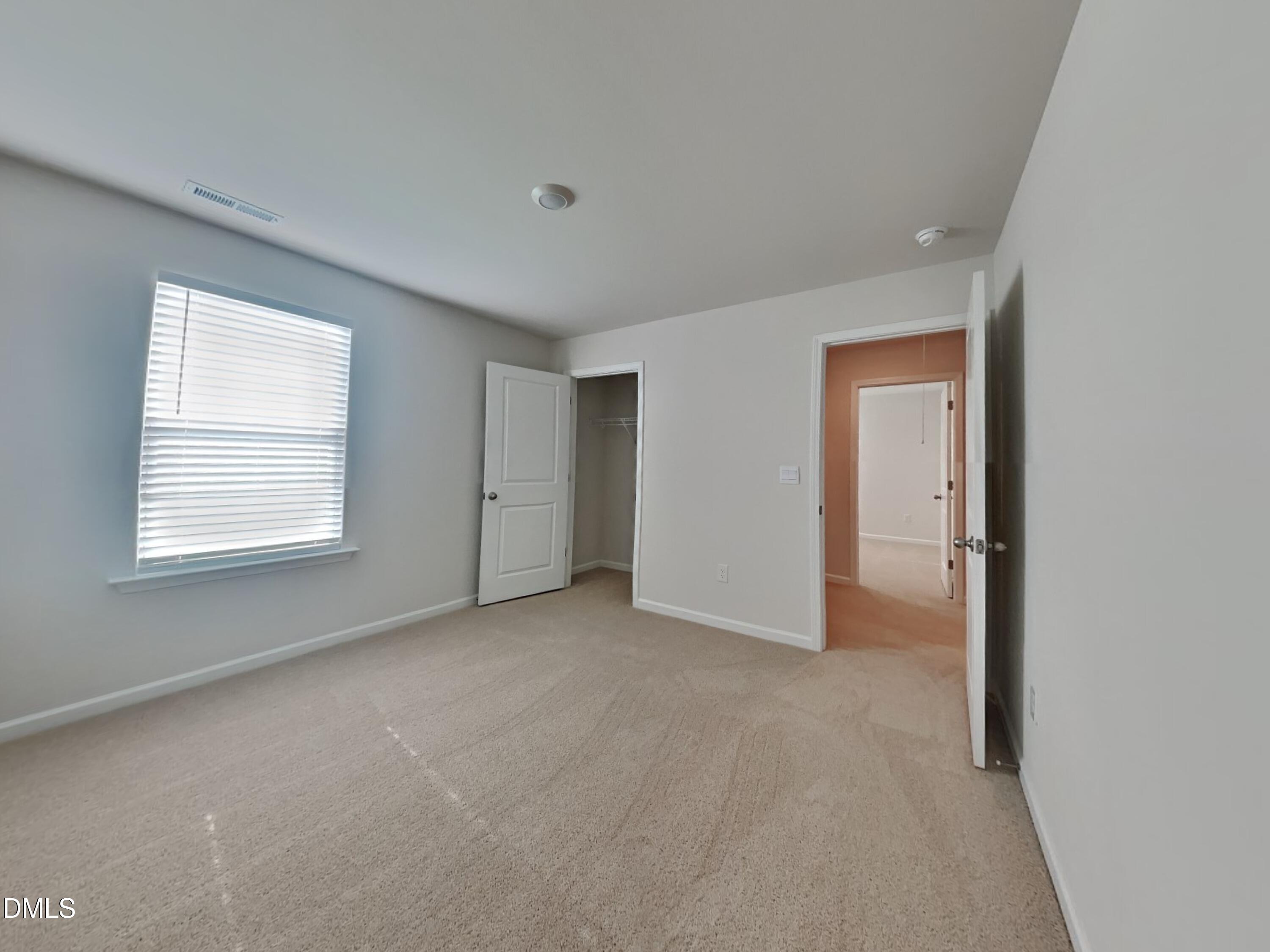 141 Chapel Drive Fuquay-Varina, NC 27526 - Photo 9 of 18 an empty room with windows and closet