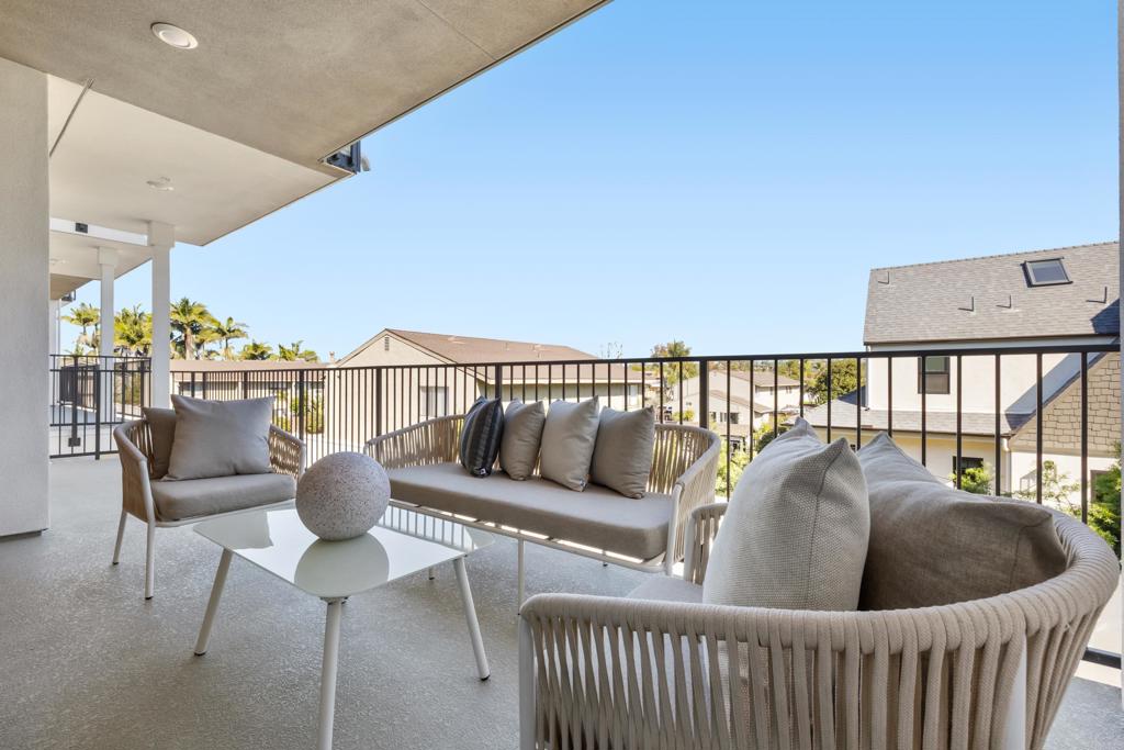 310-326 Chinquapin Avenue Carlsbad, CA 92008 - Photo 14 of 33 a roof deck with couches and wooden floor