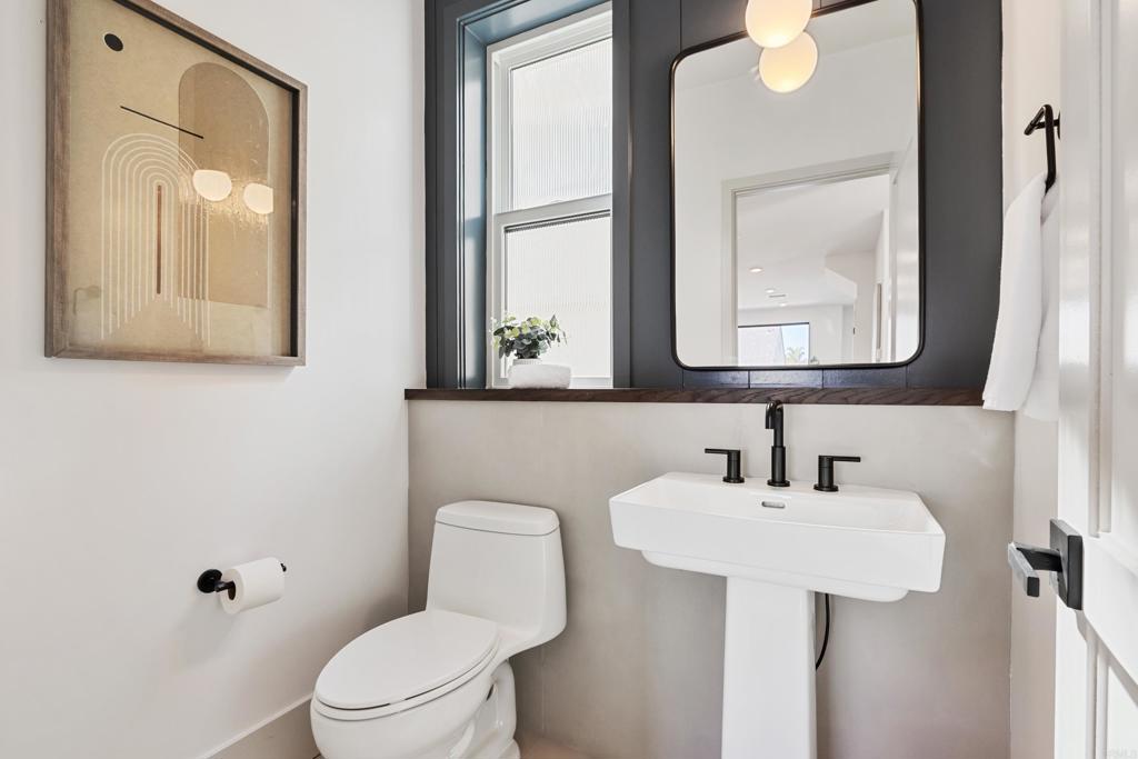 310-326 Chinquapin Avenue Carlsbad, CA 92008 - Photo 18 of 33 a bathroom with a toilet sink and mirror