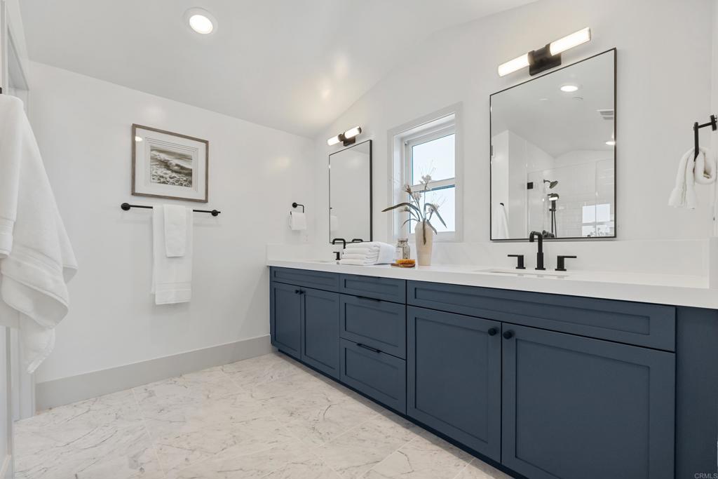 310-326 Chinquapin Avenue Carlsbad, CA 92008 - Photo 20 of 33 a bathroom with double vanity sink and a mirror