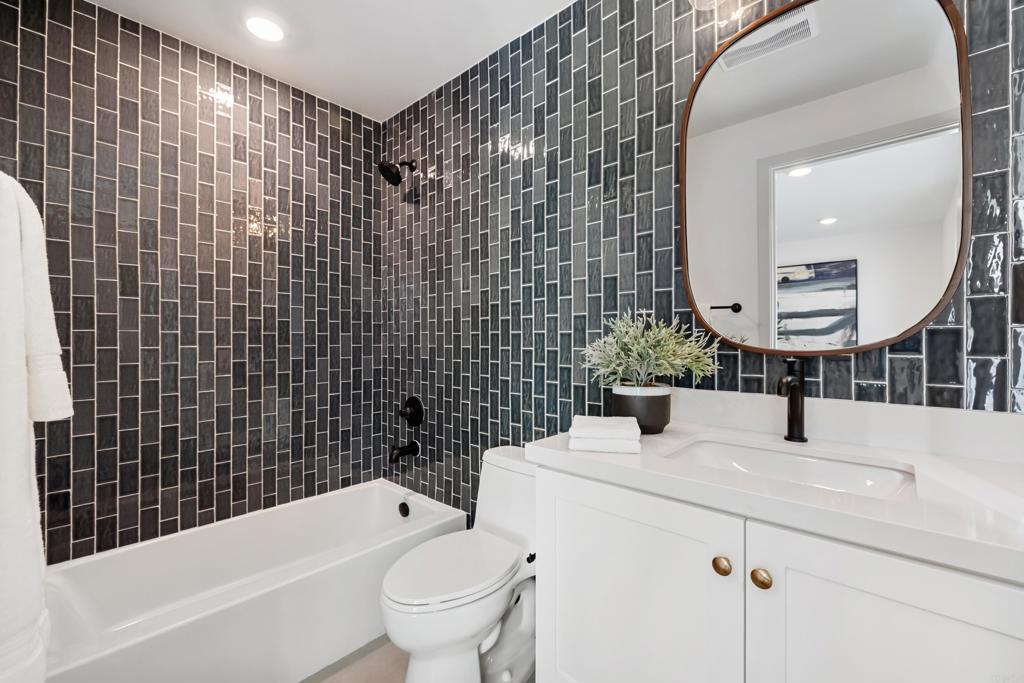 310-326 Chinquapin Avenue Carlsbad, CA 92008 - Photo 28 of 33 a bathroom with a sink toilet vanity and bathtub