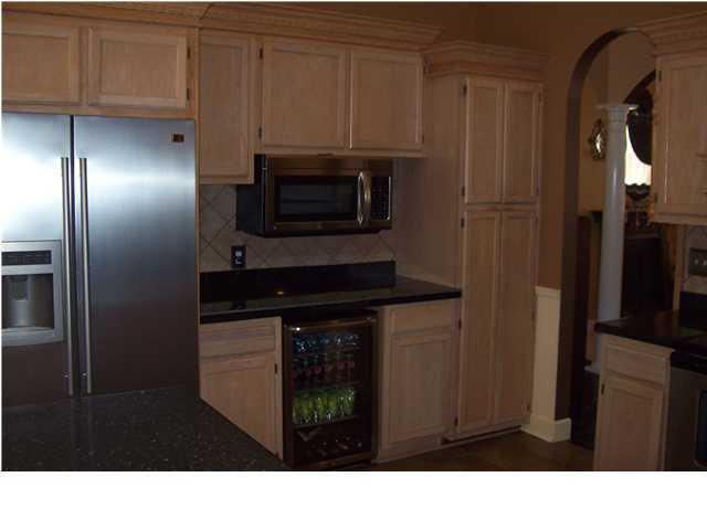 254 Ridge Lake Road Crestview, FL 32536 - Photo 3 of 29 a black and white kitchen with stainless steel appliances