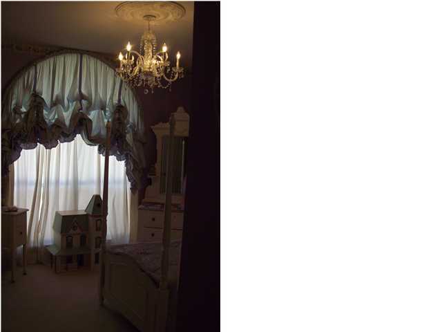 254 Ridge Lake Road Crestview, FL 32536 - Photo 23 of 29 a view of a dining room with a chandelier