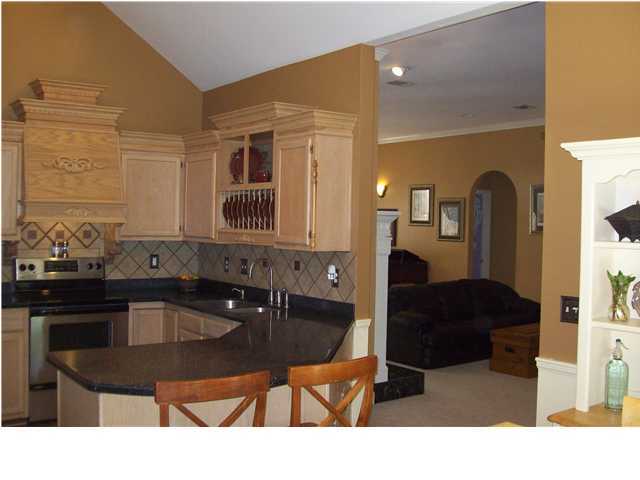 254 Ridge Lake Road Crestview, FL 32536 - Photo 4 of 29 a kitchen with a table chairs and a refrigerator