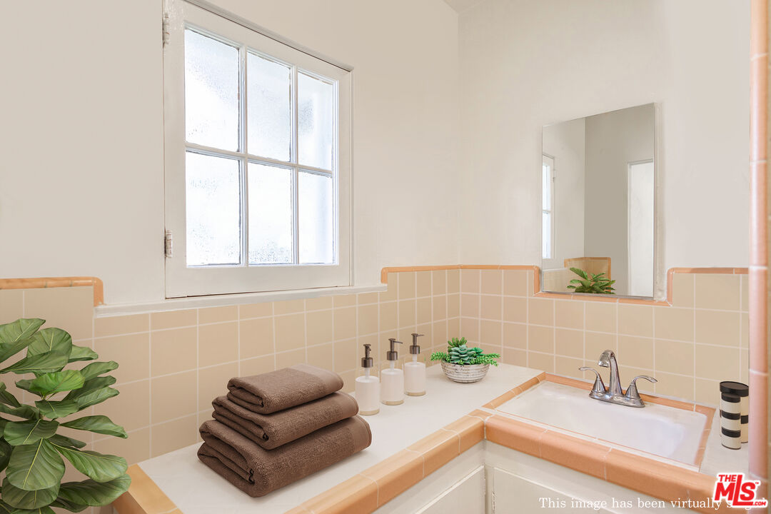 2715 Cridge Street Riverside, CA 92507 - Photo 14 of 25 a bathroom with a sink and a mirror