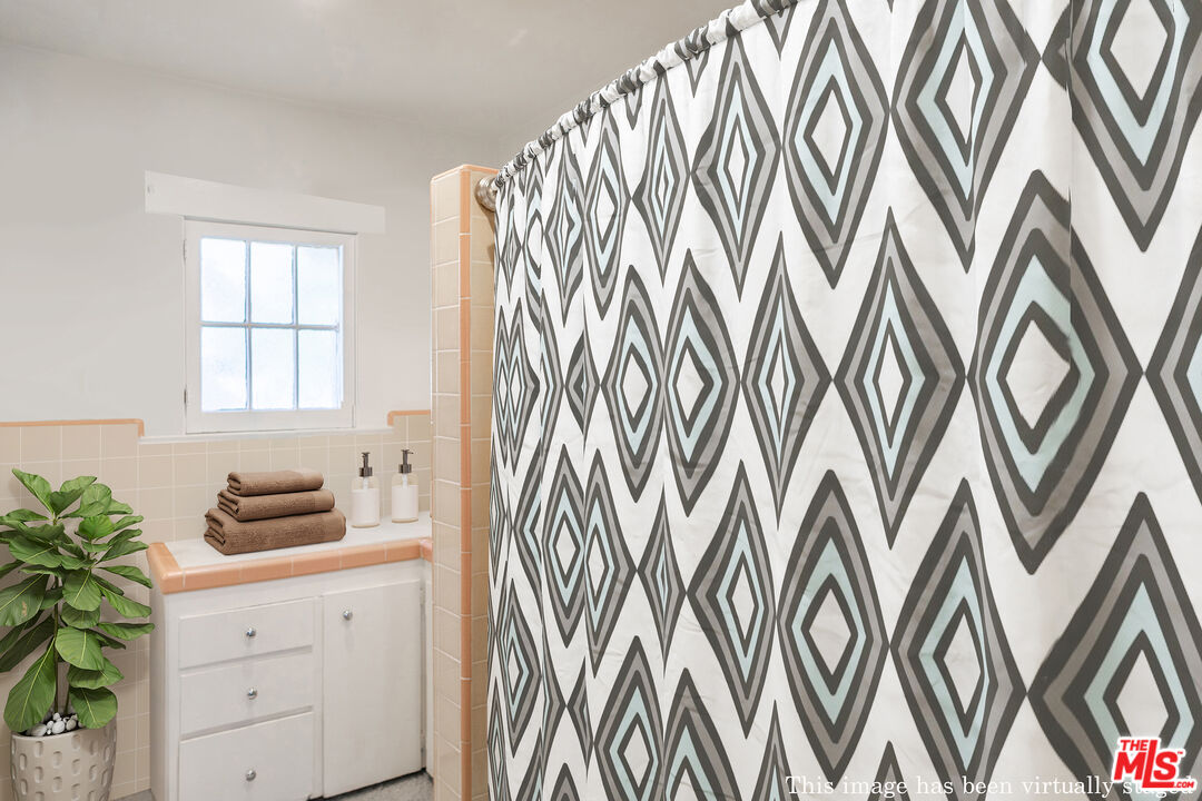 2715 Cridge Street Riverside, CA 92507 - Photo 15 of 25 a kitchen with a sink and a shower curtain