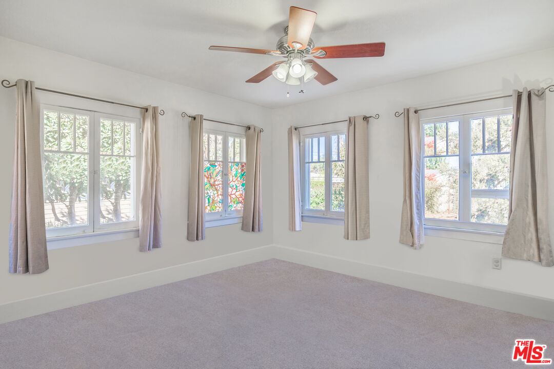 2715 Cridge Street Riverside, CA 92507 - Photo 19 of 25 a view of an empty room with chandelier fan and fire place