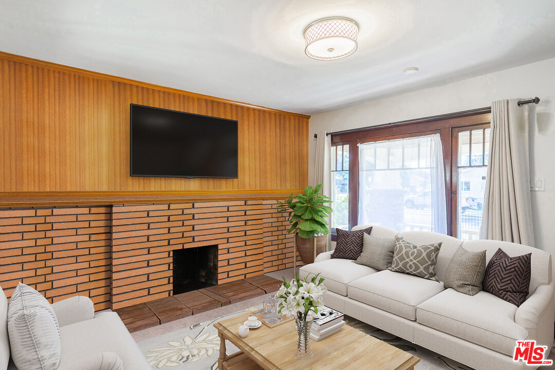 2715 Cridge Street Riverside, CA 92507 - Photo 5 of 25 a living room with furniture a fireplace and a flat screen tv