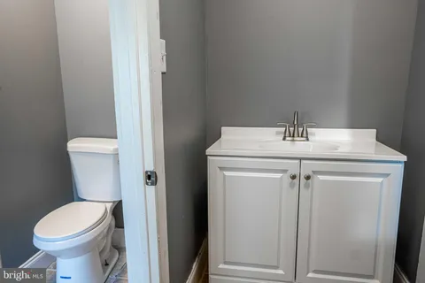 a bedroom with a bed a mirror and a window