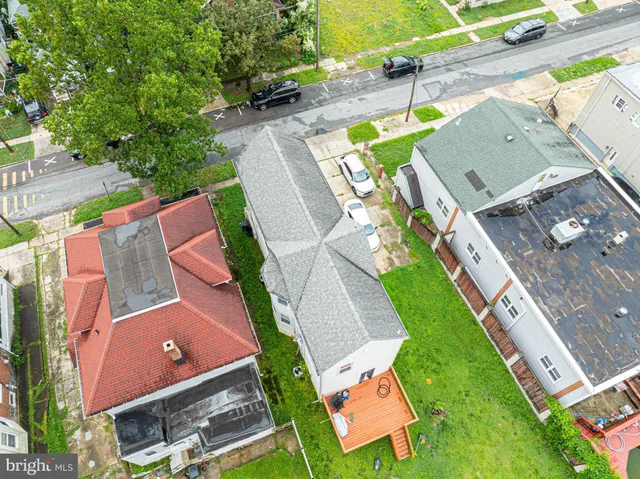 an aerial view of a house with a garden and trees