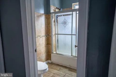 a bathroom with a glass shower door