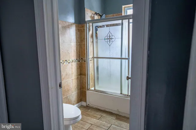 a bathroom with a glass shower door