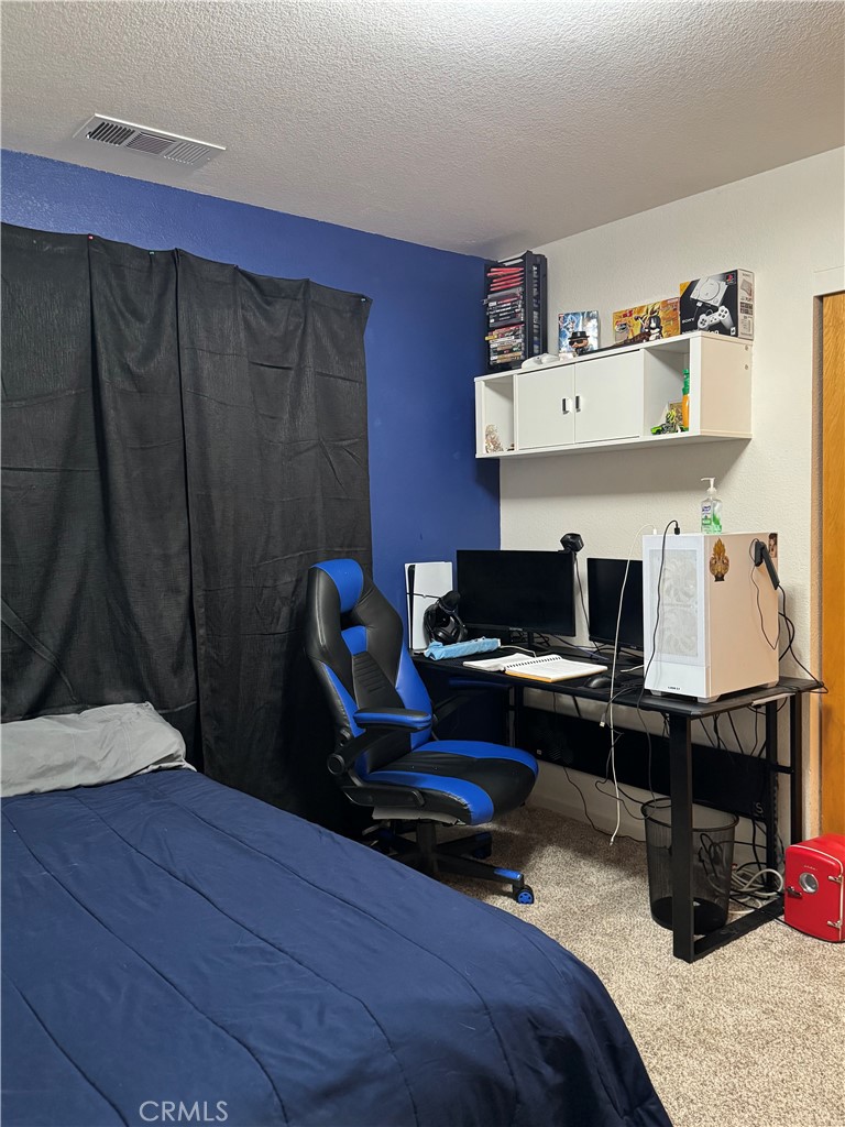 8220 Marek Road Los Molinos, CA 96055 - Photo 13 of 27 a bedroom with a bed and a desk