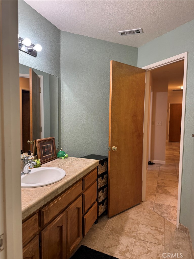 8220 Marek Road Los Molinos, CA 96055 - Photo 20 of 27 a bathroom with a sink a mirror and a shower