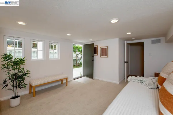 a bedroom with furniture and a wooden floor
