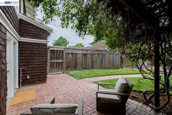 a view of a house with backyard sitting area and garden