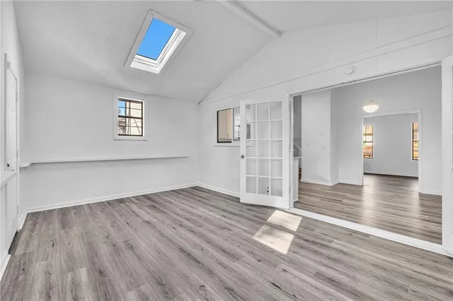 wooden floor in an empty room with a window