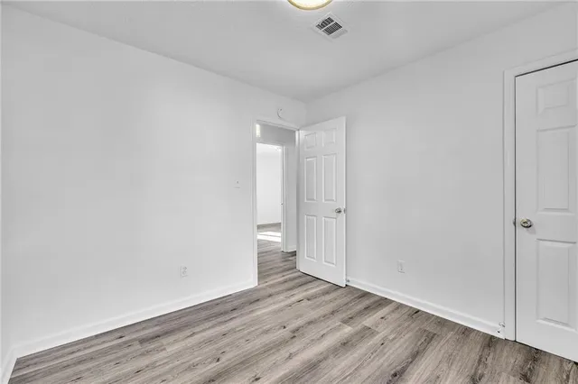 a view of an empty room and wooden floor