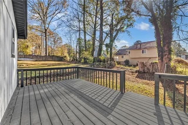 a view of balcony with wooden floor and fence