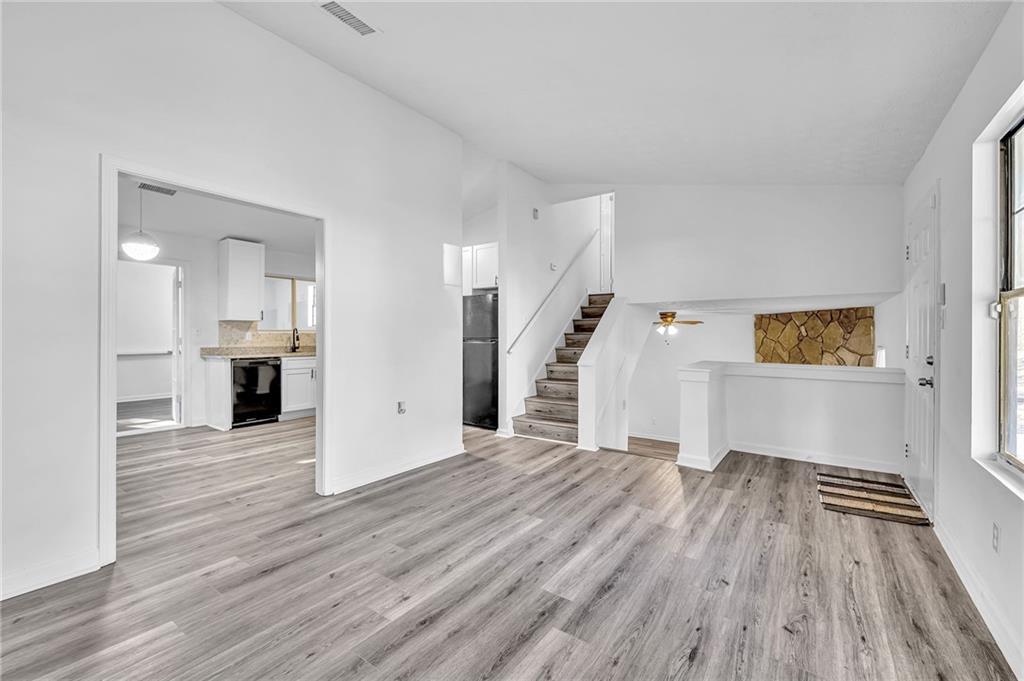 3959 Wood Path Drive Stone Mountain, GA 30083 - Photo 9 of 37 a view of a big room with wooden floor and kitchen