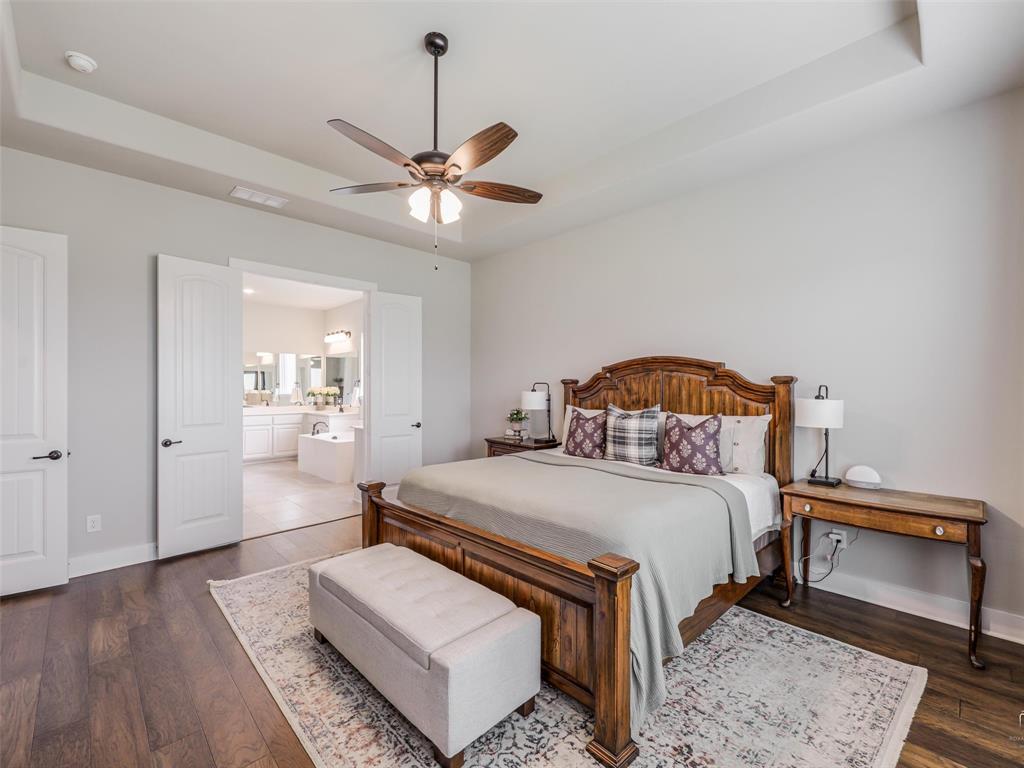 544 Majors Road Van Alstyne, TX 75495 - Photo 14 of 36 a bedroom with a bed and a chandelier
