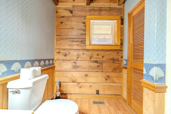 a bathroom with a toilet and a shower