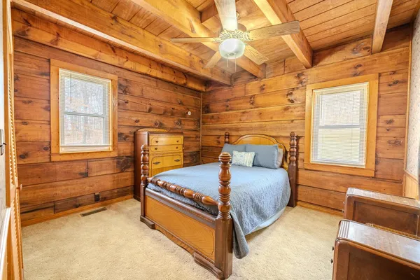 a bedroom with bed and window