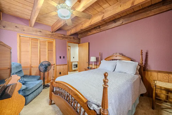 a bed room with a bed and a chandelier