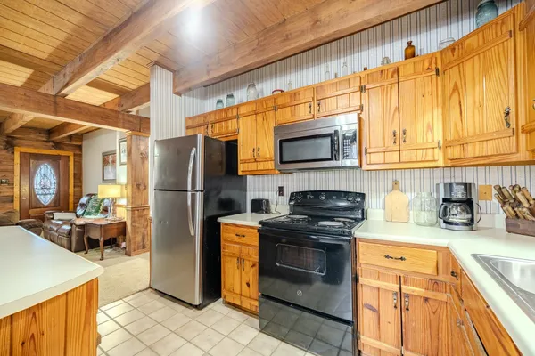 a kitchen with stainless steel appliances granite countertop a refrigerator stove and sink