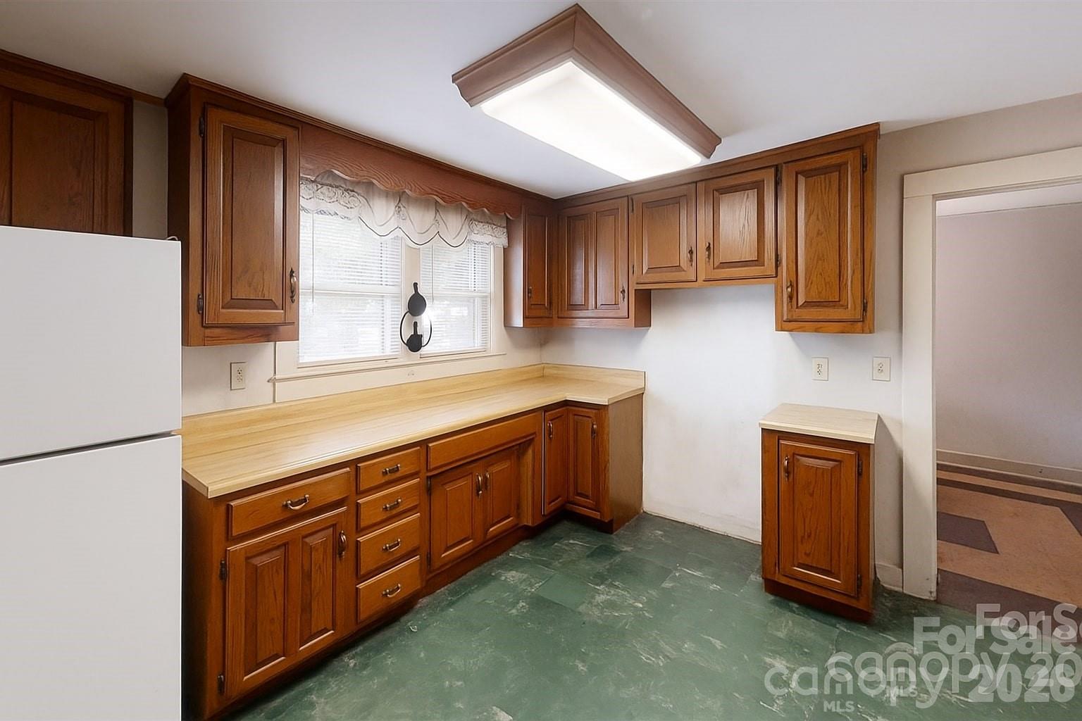 21 Maple Avenue Candler, NC 28715 - Photo 15 of 28 a kitchen with stainless steel appliances granite countertop wooden cabinets a sink and a window