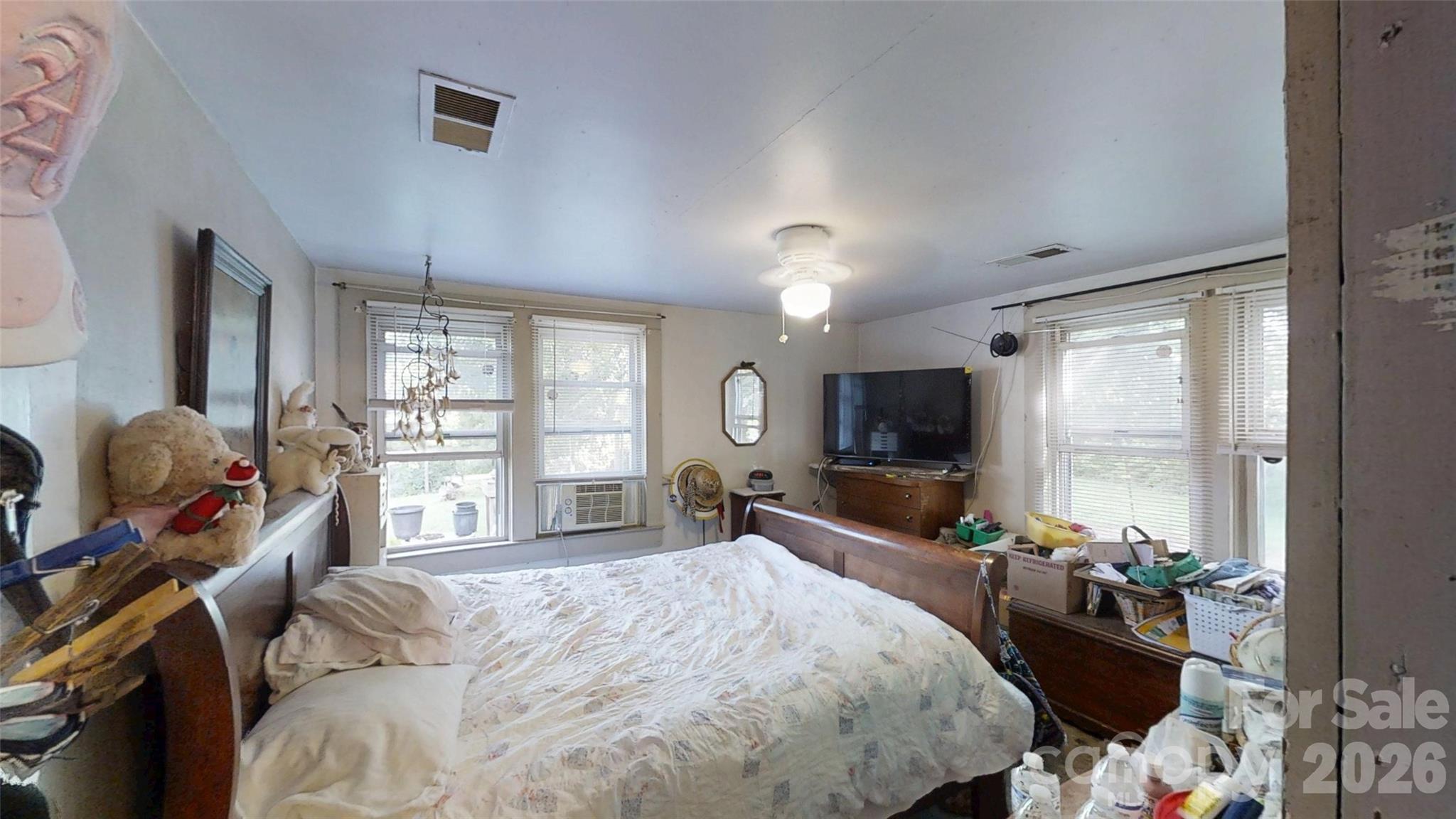 21 Maple Avenue Candler, NC 28715 - Photo 16 of 28 a bed room with a bed television and a large window