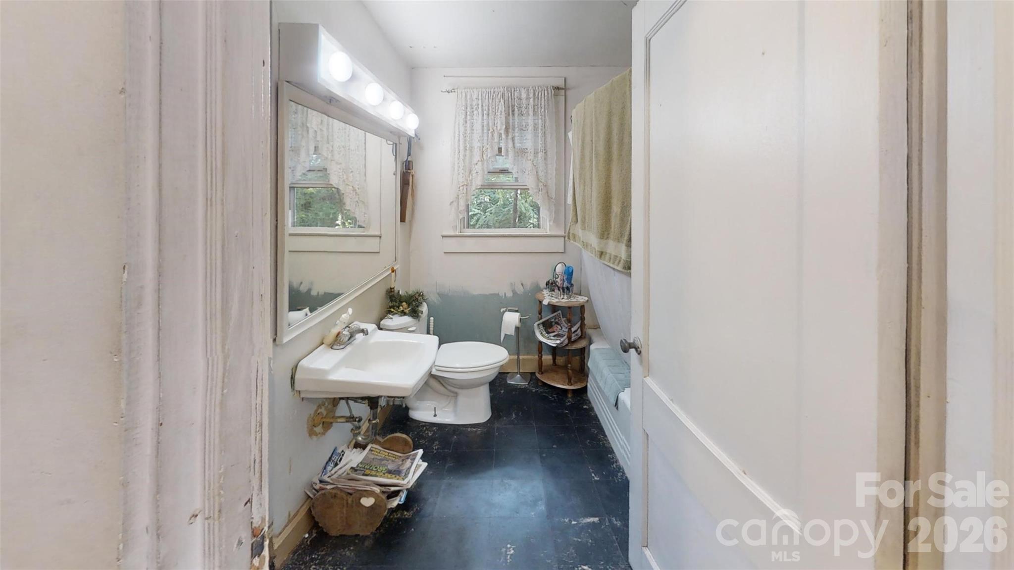 21 Maple Avenue Candler, NC 28715 - Photo 24 of 28 a bathroom with a sink and a mirror