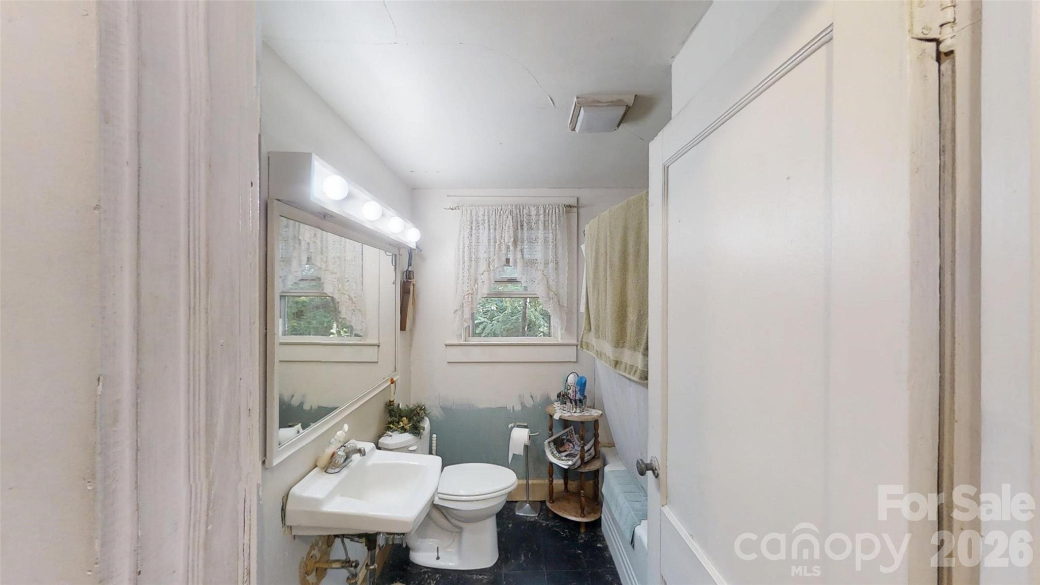 21 Maple Avenue Candler, NC 28715 - Photo 26 of 28 a bathroom with a sink toilet and a mirror
