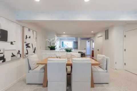 a room with furniture a flat screen tv and a couch