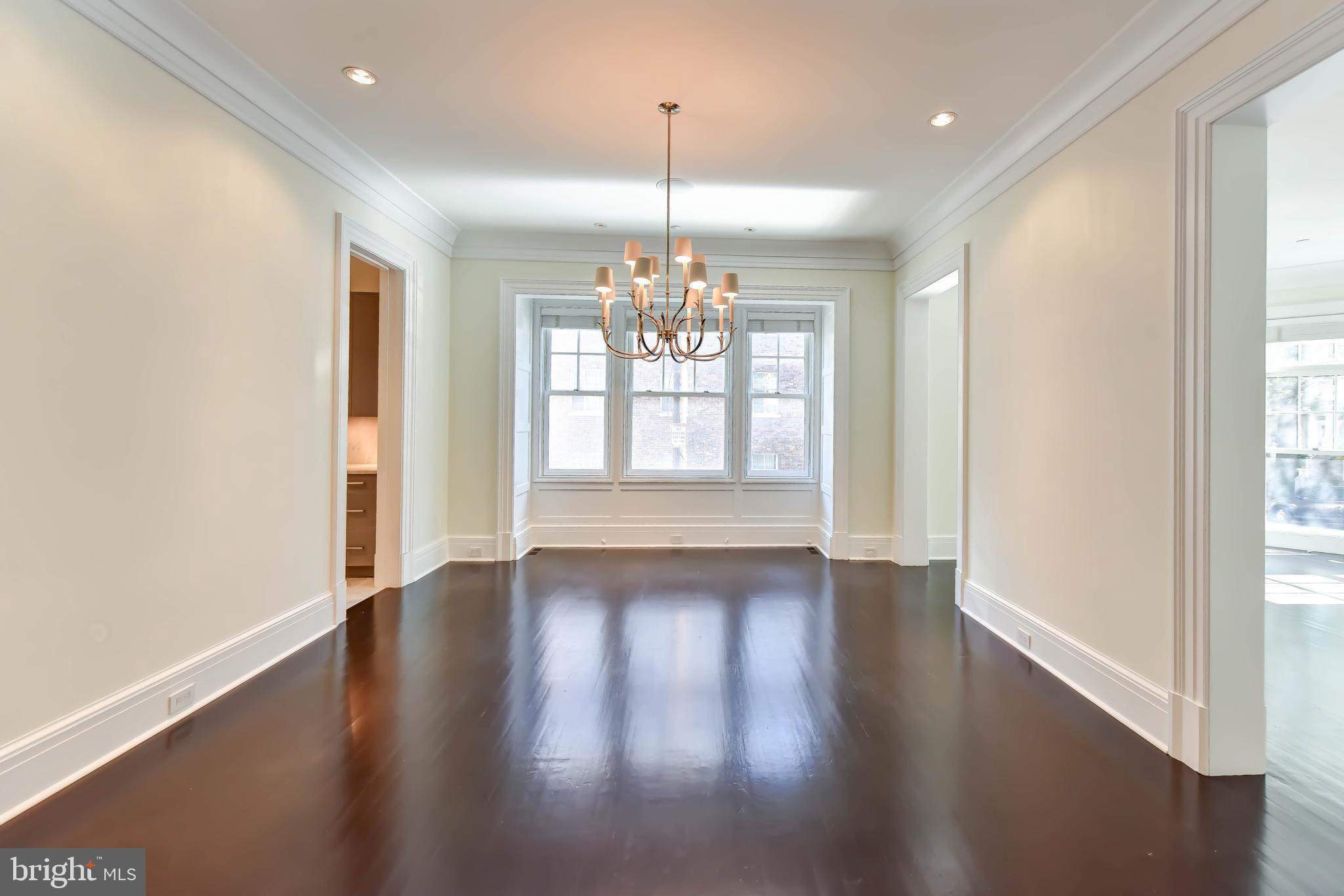 2733 Cathedral Avenue Northwest Washington, DC 20008 - Photo 2 of 10 a view of an empty room with wooden floor and a window