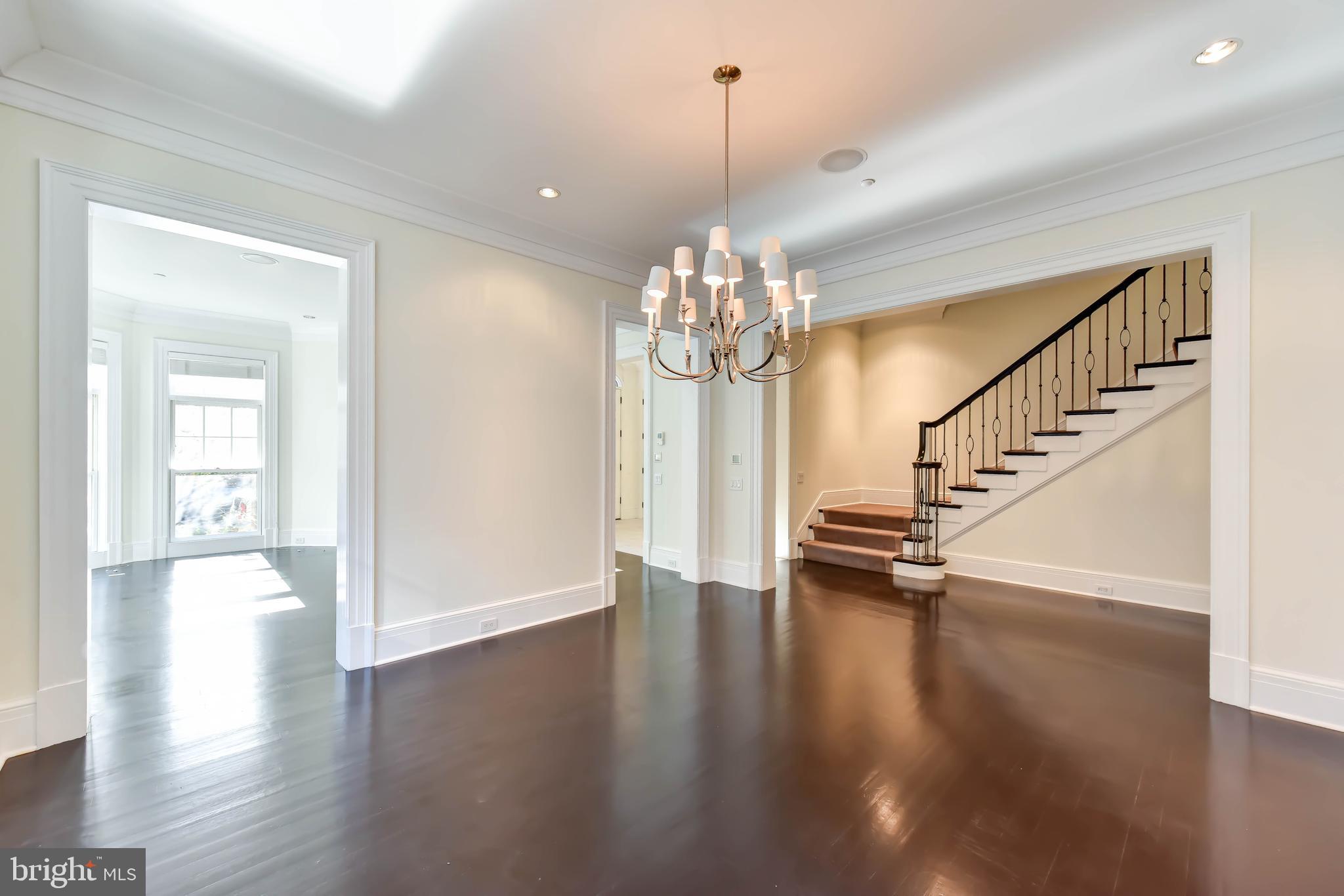 2733 Cathedral Avenue Northwest Washington, DC 20008 - Photo 3 of 10 a view of a room with wooden floor staircase and a chandelier