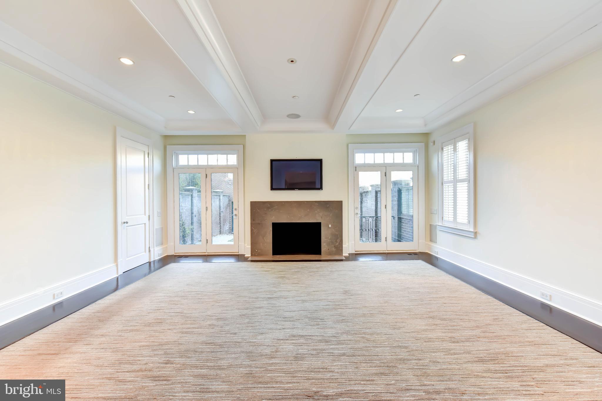 2733 Cathedral Avenue Northwest Washington, DC 20008 - Photo 6 of 10 an empty room with windows and a fireplace